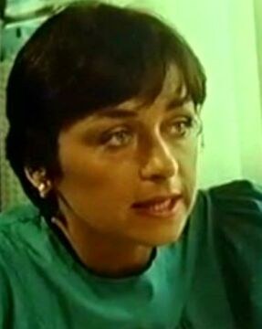 Cathy Ménard in a green top in a 1987 film still